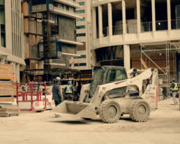 Busy construction site with workers and machinery.