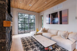 A cozy living room featuring a comfortable couch, a stylish coffee table, and a warm fireplace for relaxation.