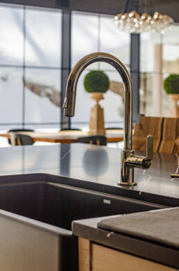 A modern kitchen sink with a sleek faucet and a spacious counter, ideal for meal preparation and cleaning.