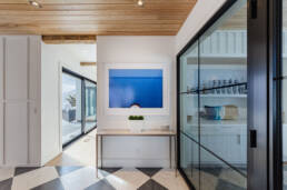 A spacious hallway adorned with a large artwork on the wall, creating a focal point in the corridor.